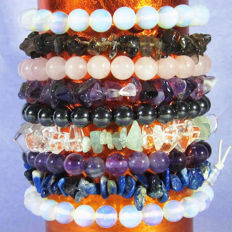 a stack of 8 different crystal chip and power bead bracelets