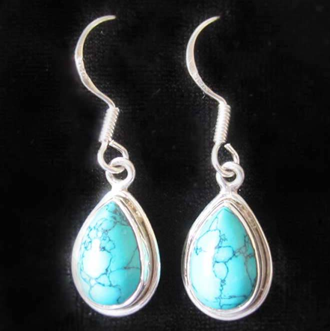 a pair of turquoise pear shaped earrings set in 925 silver