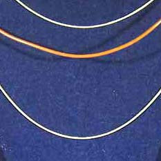 two silver chains and a brown leather neck cord