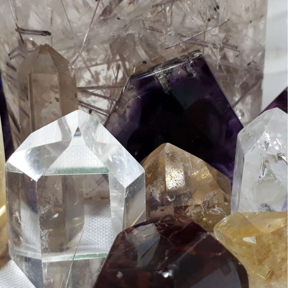 close up of polished crystal points made from quartz, amethyst and citrine