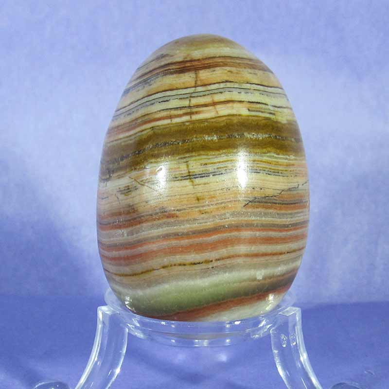 banded onyx carved egg on clear egg stand