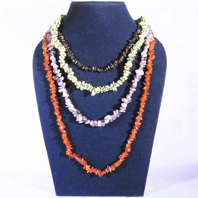 4 crystal chip necklaces around a dark blue velvet mannequin