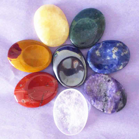 8 different crystal thumb stones on a light purple background