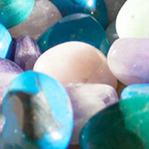 close up of tumbled crystals, mainly coloured blue, green and white